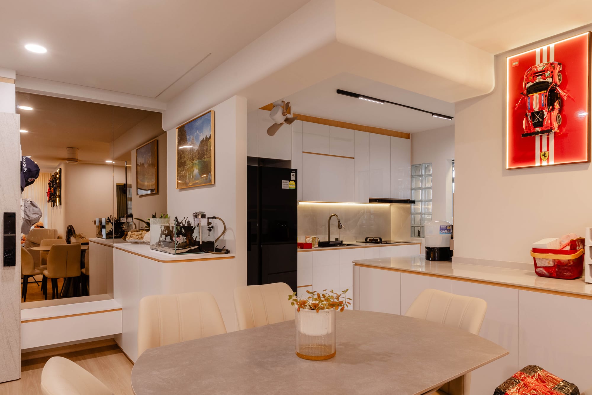 Wide view of the all-white dining and kitchen area at Fernvale St